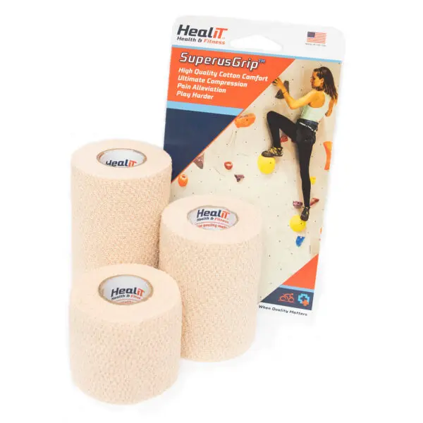 Three beige elastic compression wrap bandage rolls are shown in front of HealIT SuperusGrip packaging, which features a woman rock climbing and product details.