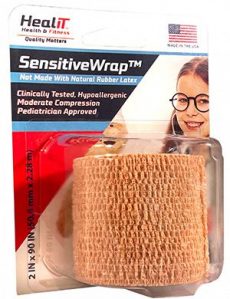 HealIT SensitiveWrap elastic compression wrap in retail packaging, featuring product details and a smiling child. The tan wrap is latex-free, hypoallergenic, pediatrician approved, and perfect for gentle support.